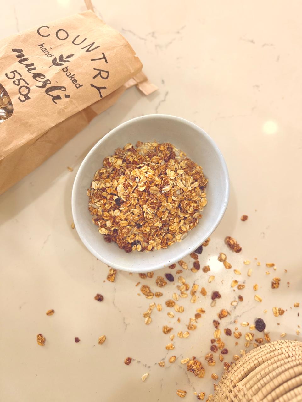 Close up of Country Muesli in a bowl showing the golden baked texture